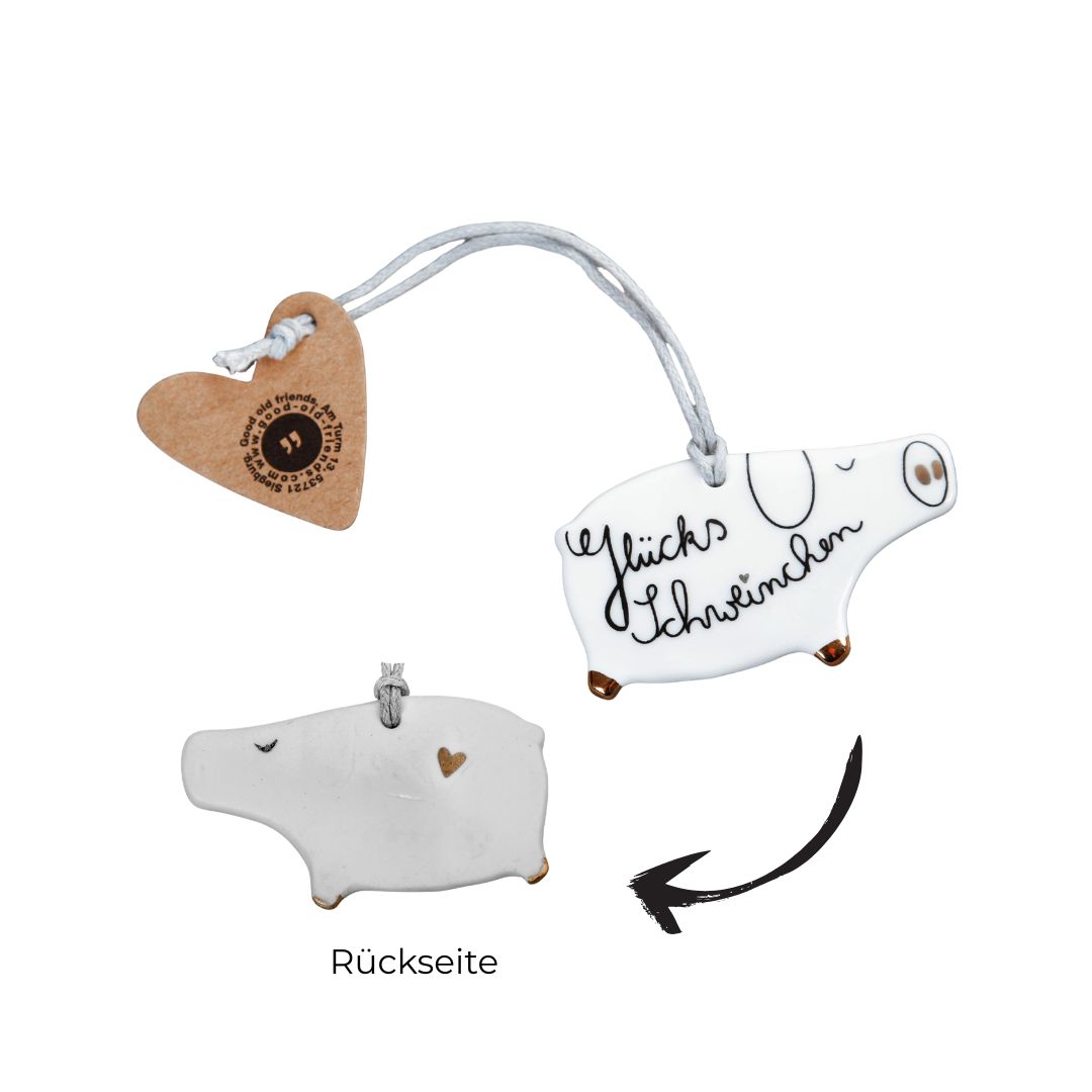 Glücksbringerchen Glücksschweinchen von Good old friends aus weißem Porzellan mit Schriftzug Glücksschweinchen, Kordel und Herz-Tag sowie der Rückseite mit kleinem Herz-Detail