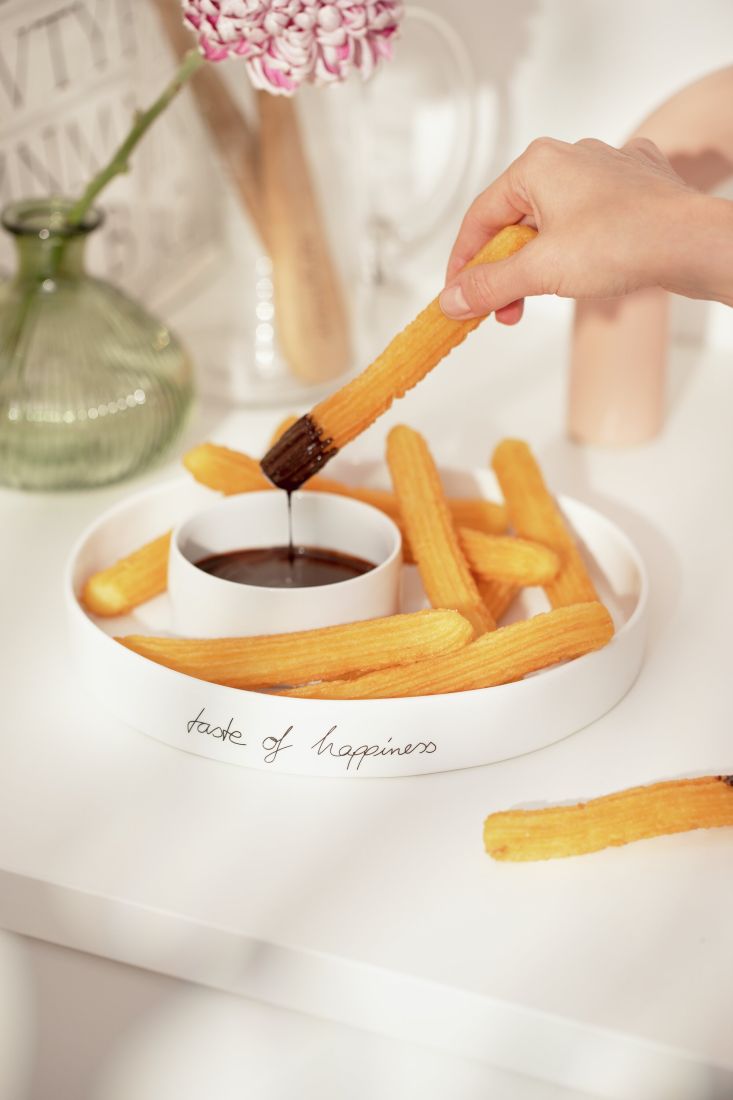 Befüllte räder Schale mit Nachos im äußeren Ring und Dip in der Mitte auf einer gedeckten Tafel