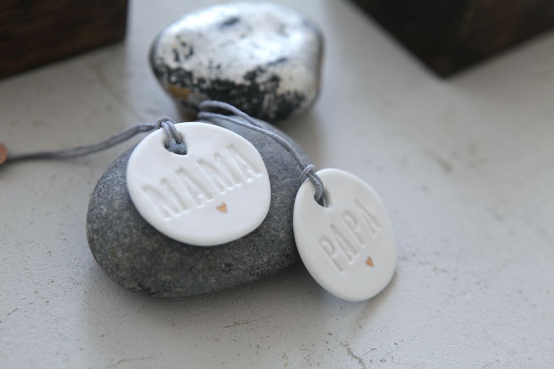 Nahaufnahme der unglasierten Vorderseite des Good old friends Familientalers mit 'Mama'-Relief und goldenem Herz