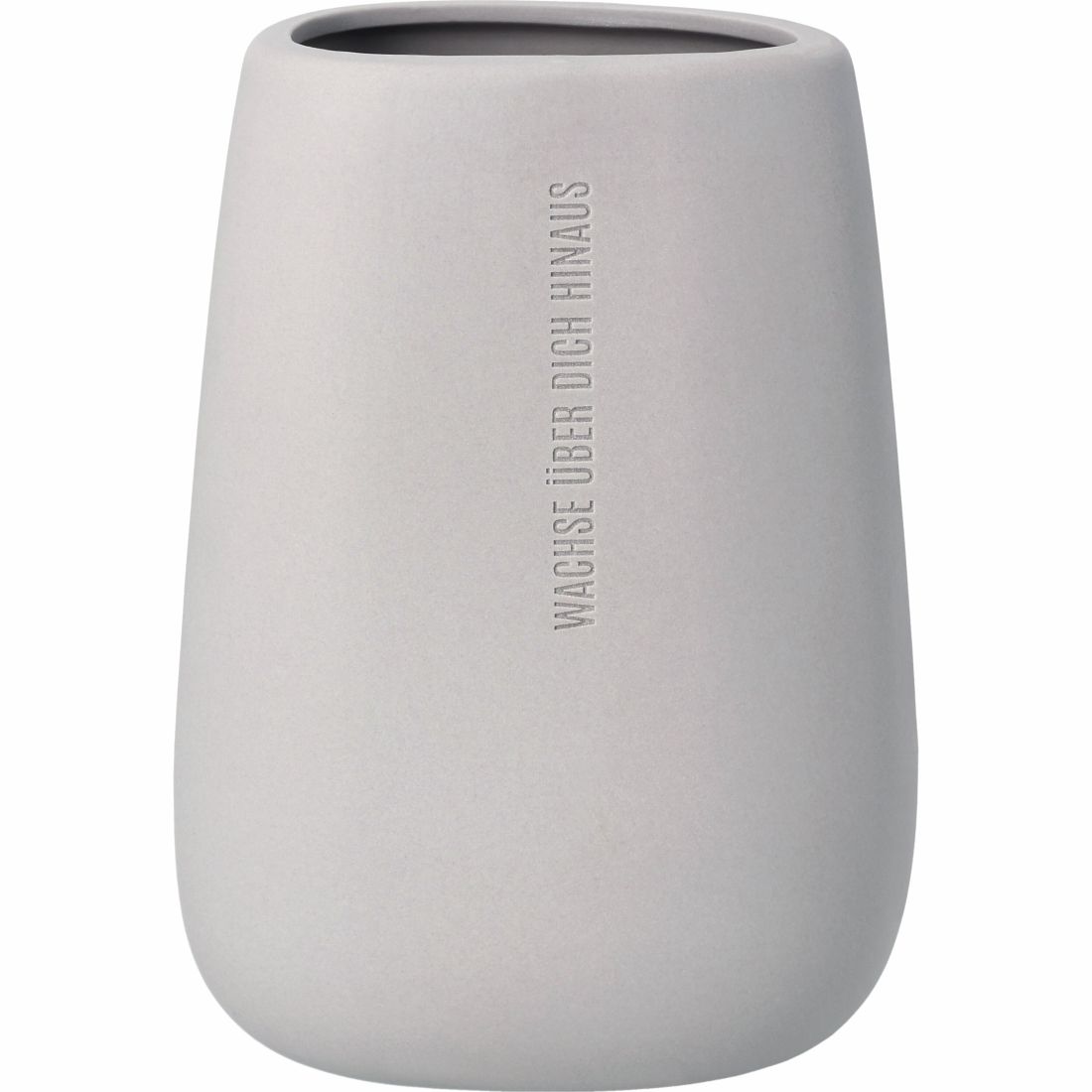 Nahaufnahme des Relief-Schriftzugs Wachse über dich hinaus auf der grauen räder Vase