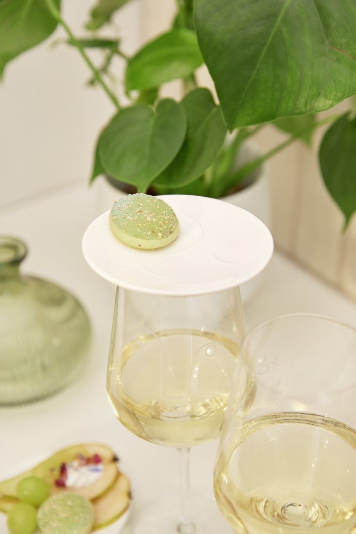 räder Wein Topper Genießer auf einem Weinglas liegend mit einem Macaron als Snack