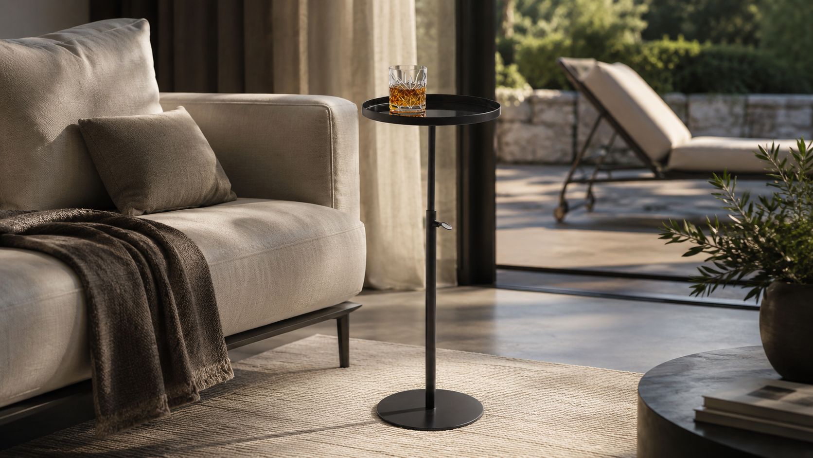 Der schwarze Philippi Beistelltisch TOM höhenverstellbar neben einem modernen Sofa platziert